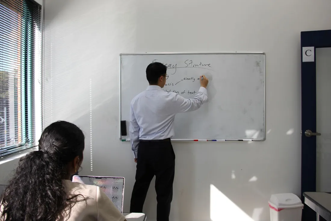 A Lux Tuition tutor teaching at the whiteboard